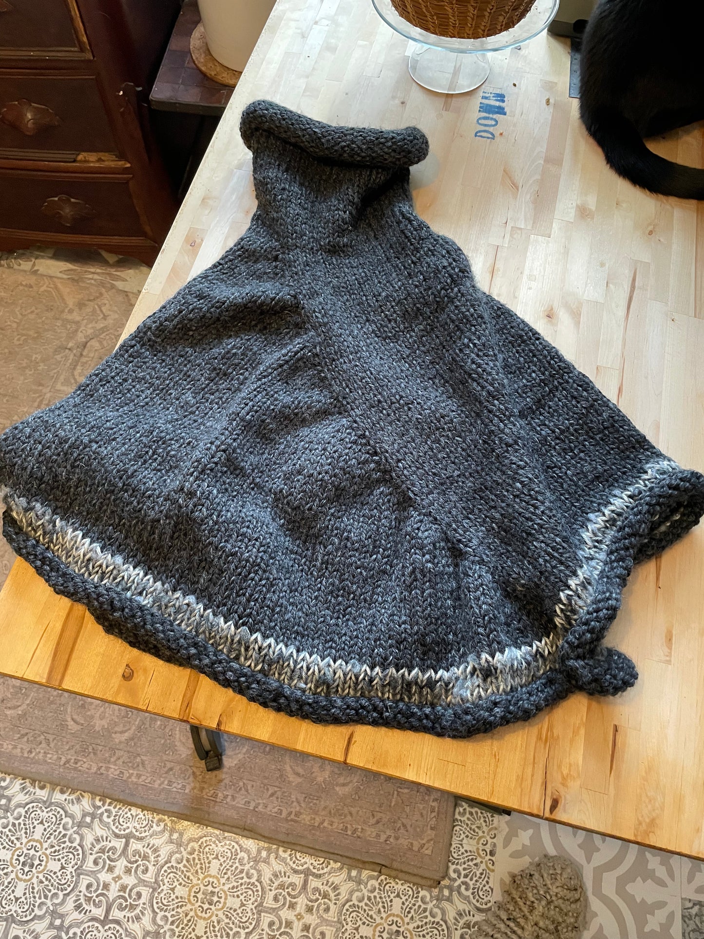 Hand knitted rolled turtleneck poncho charcoal grey with striped edging