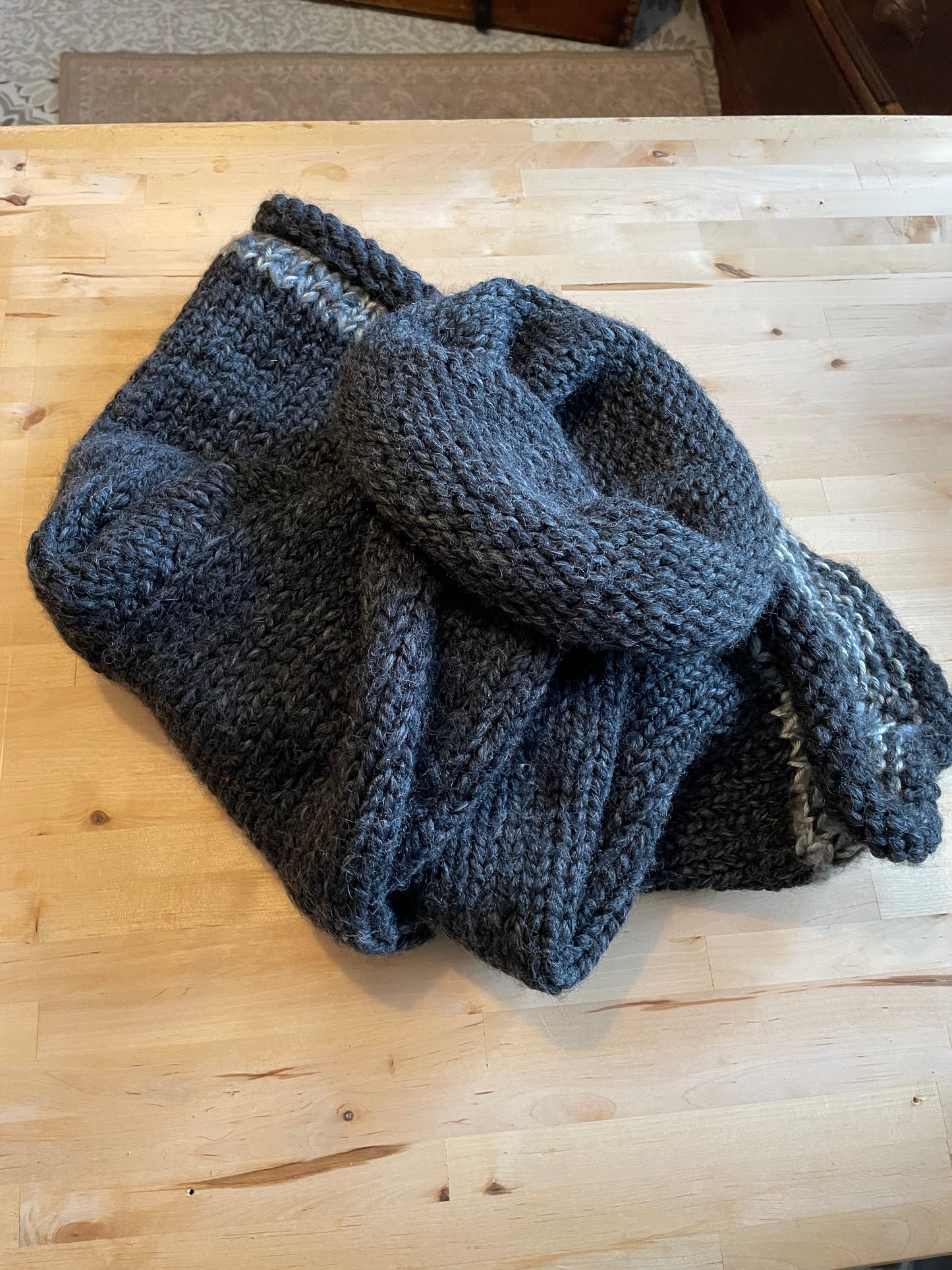 Hand knitted rolled turtleneck poncho charcoal grey with striped edging