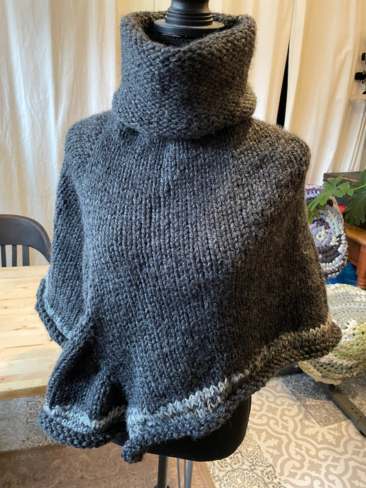 Hand knitted rolled turtleneck poncho charcoal grey with striped edging