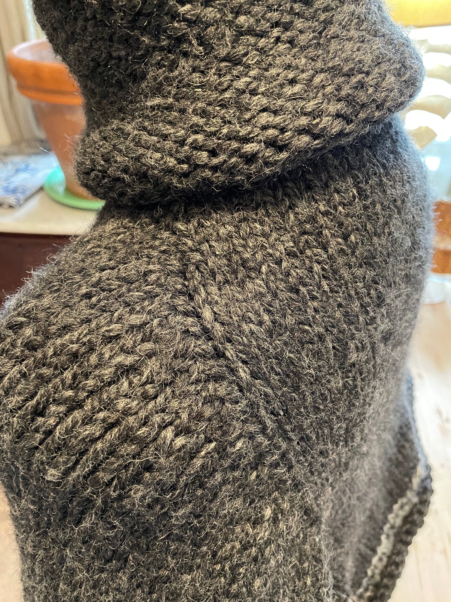 Hand knitted rolled turtleneck poncho charcoal grey with striped edging